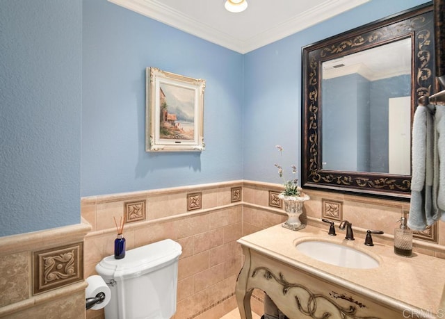 bathroom featuring ornamental molding, toilet, tile walls, and vanity