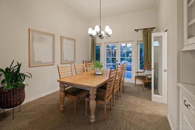 dining room with a notable chandelier, carpet floors, ornamental molding, and french doors