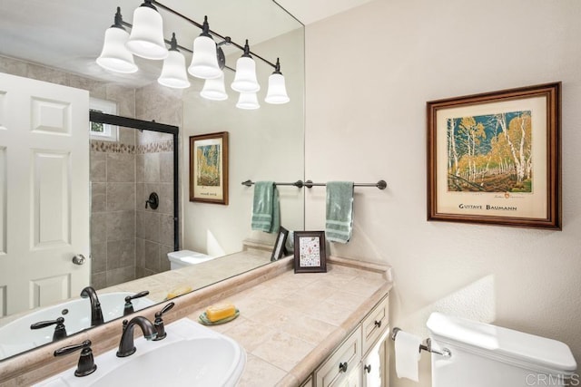 bathroom with vanity, toilet, and a shower with shower door