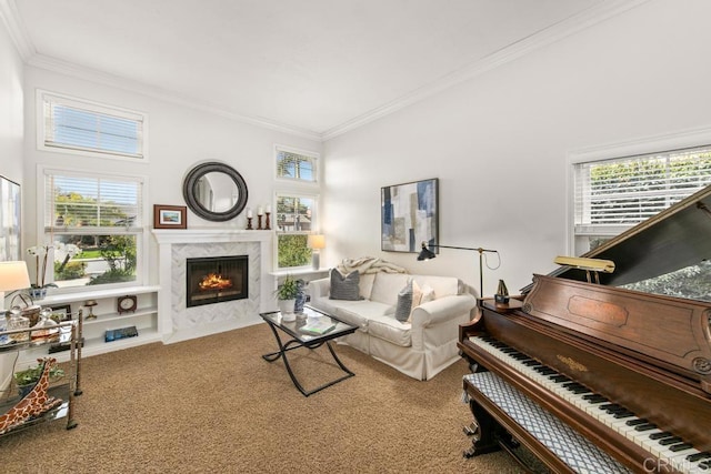 living room featuring crown molding, a fireplace, plenty of natural light, and carpet flooring