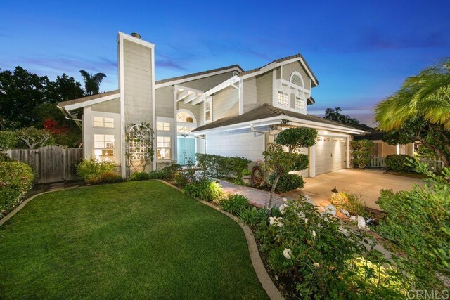 view of front of home featuring a garage and a yard