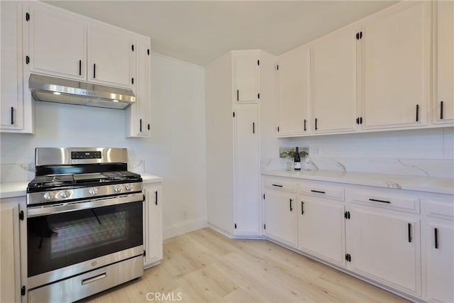 kitchen with gas range, white cabinetry, and light hardwood / wood-style flooring