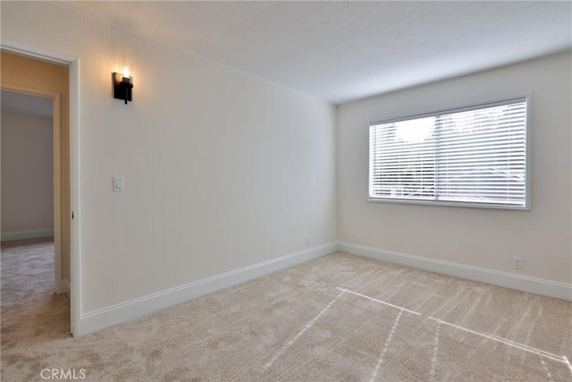 unfurnished room with light carpet