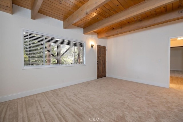 unfurnished room featuring beamed ceiling, carpet, and wooden ceiling