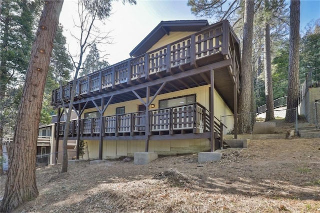 rear view of property featuring a deck