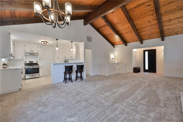 unfurnished living room with light colored carpet, a notable chandelier, and wood ceiling