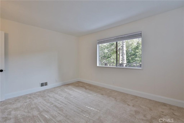 unfurnished room with light carpet