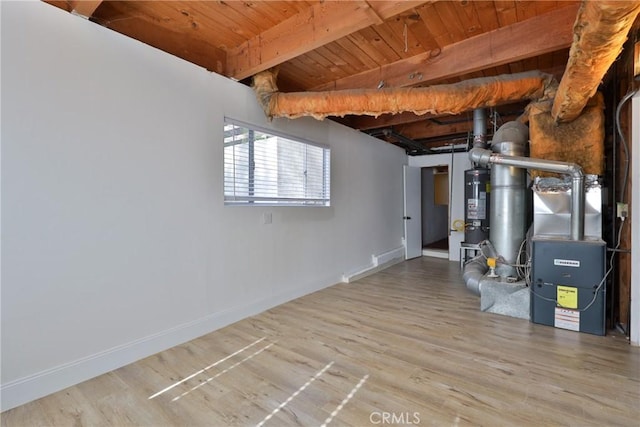 basement with water heater, hardwood / wood-style flooring, heating unit, and wooden ceiling