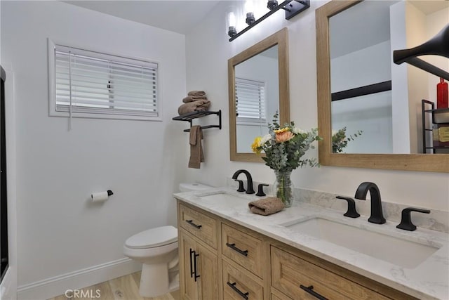 bathroom with vanity, toilet, and hardwood / wood-style floors