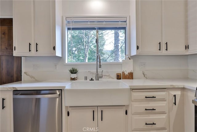 kitchen featuring dishwasher, sink, light stone countertops, and white cabinets