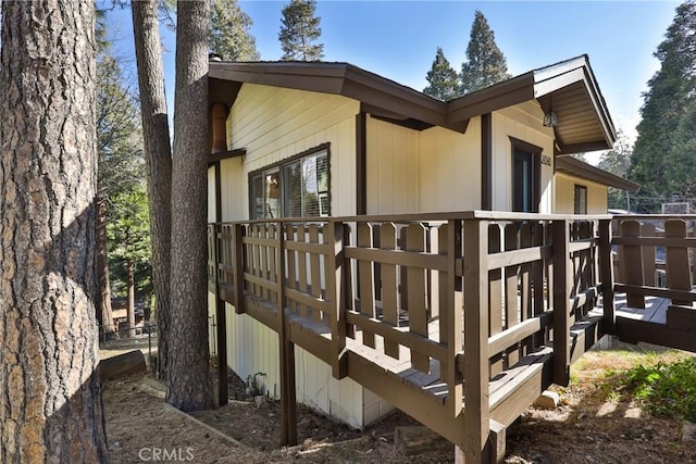 view of side of home with a deck