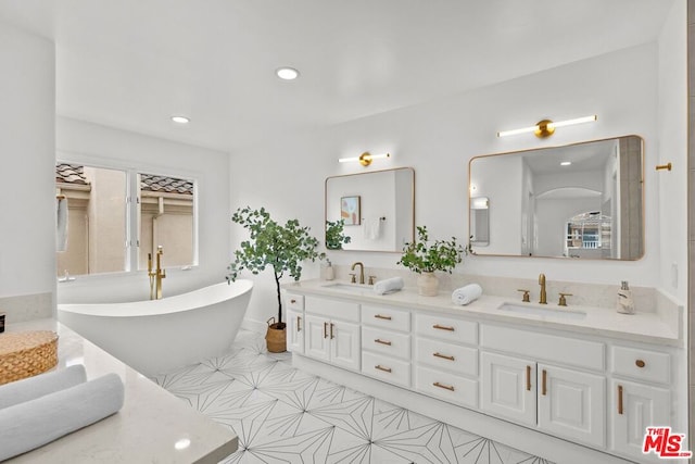 bathroom with vanity and a tub