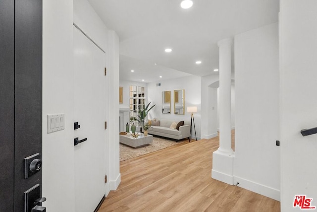 hallway with hardwood / wood-style floors