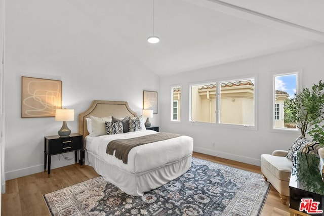 bedroom featuring wood-type flooring and vaulted ceiling