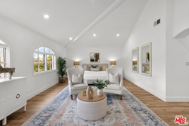 bedroom with high vaulted ceiling and light hardwood / wood-style floors