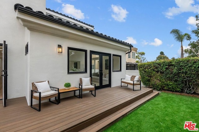 wooden deck featuring a lawn