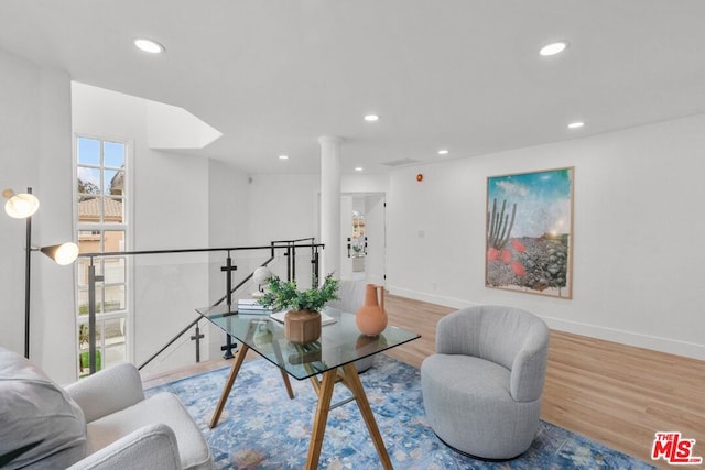 interior space featuring hardwood / wood-style flooring and decorative columns