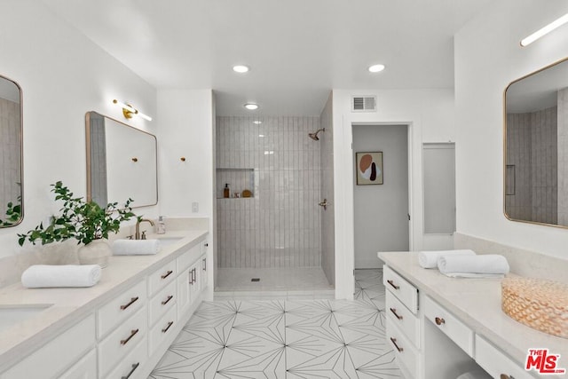 bathroom featuring vanity and tiled shower