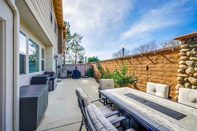 view of patio / terrace featuring fence and outdoor dining space