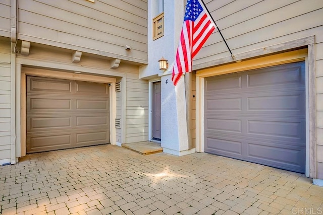 garage featuring decorative driveway