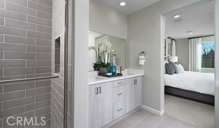 bathroom featuring walk in shower, vanity, and tile patterned flooring