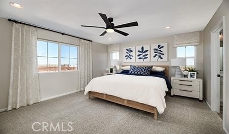 bedroom featuring light colored carpet and ceiling fan