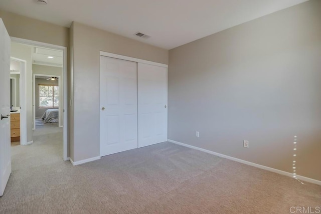 unfurnished bedroom featuring a closet and carpet