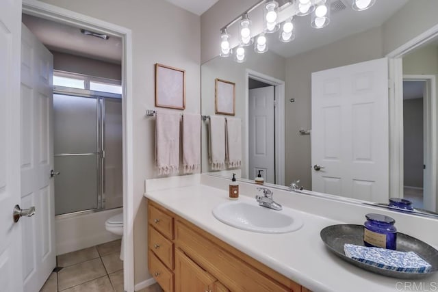 full bathroom with vanity, tile patterned floors, toilet, and combined bath / shower with glass door