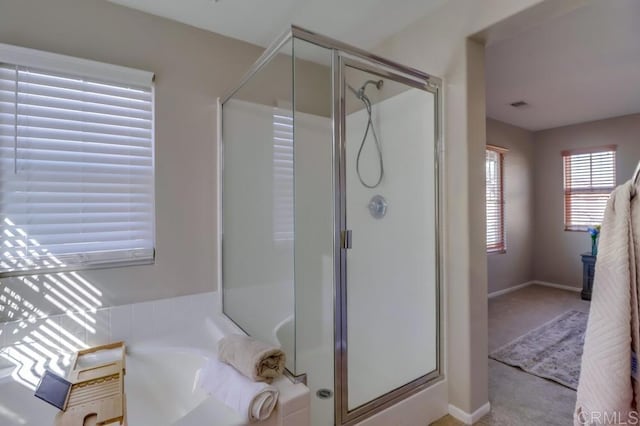 bathroom featuring separate shower and tub