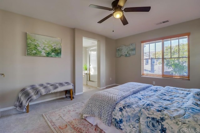 carpeted bedroom featuring ceiling fan and ensuite bathroom