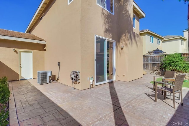 back of house with a patio and central air condition unit