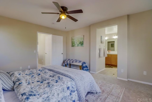 carpeted bedroom with ceiling fan and ensuite bath