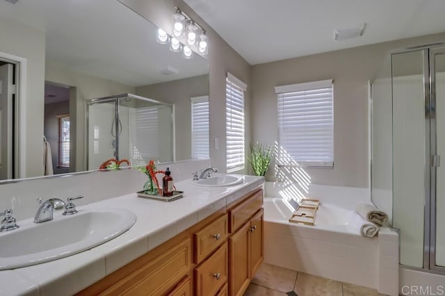 bathroom featuring tile patterned flooring, vanity, plenty of natural light, and separate shower and tub