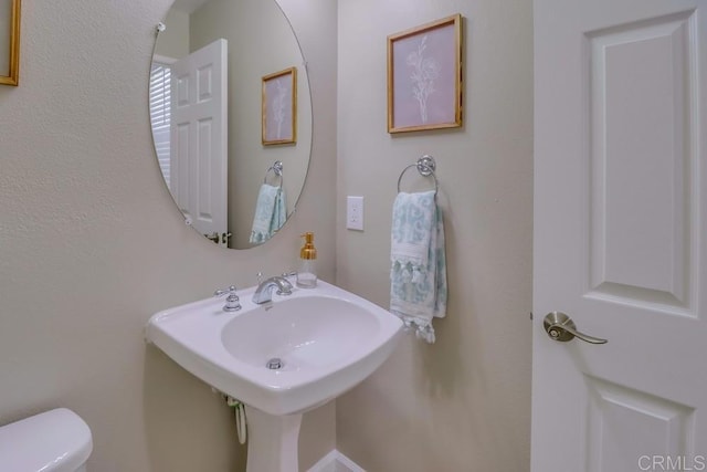 bathroom with toilet and sink