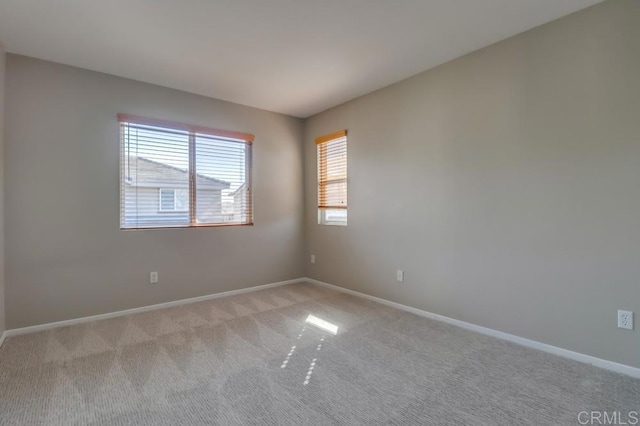 empty room featuring light carpet