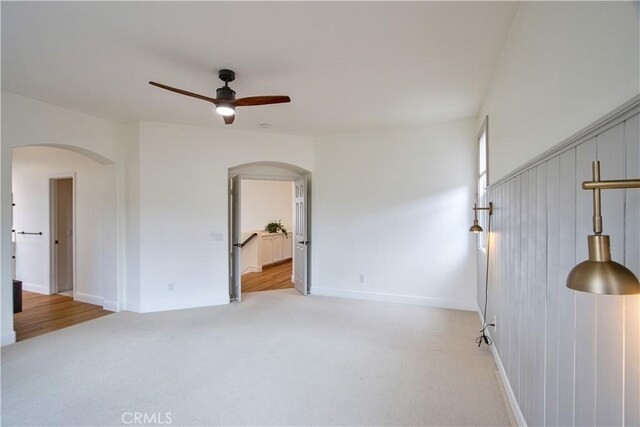 spare room featuring ceiling fan and light colored carpet