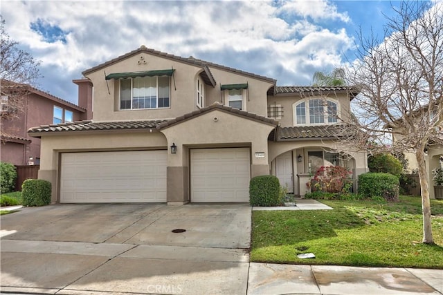 mediterranean / spanish-style house featuring a garage and a front yard