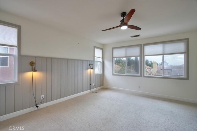 spare room with light colored carpet and ceiling fan