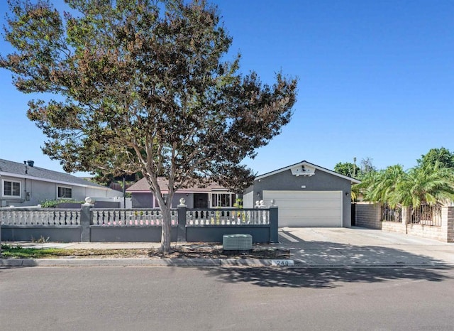 ranch-style home featuring cooling unit and a garage