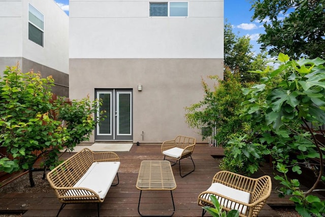 rear view of property with a wooden deck and french doors