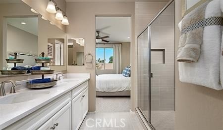 bathroom with vanity, ceiling fan, and walk in shower