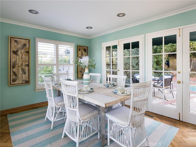 dining area with crown molding and light parquet floors