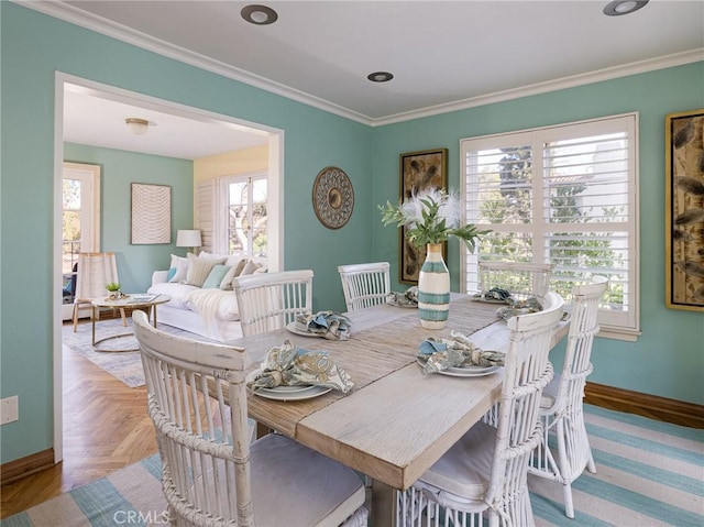 dining area featuring light parquet flooring and ornamental molding