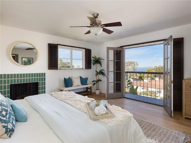 bedroom featuring ceiling fan, access to exterior, and light wood-type flooring