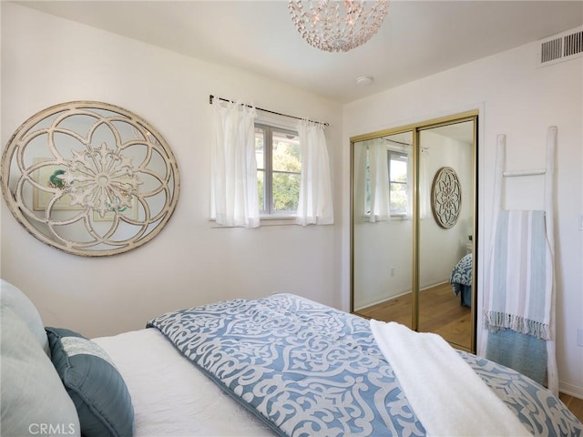 bedroom with hardwood / wood-style floors and a closet