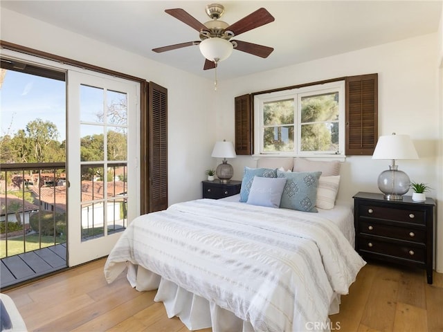 bedroom with ceiling fan, access to exterior, and light hardwood / wood-style flooring