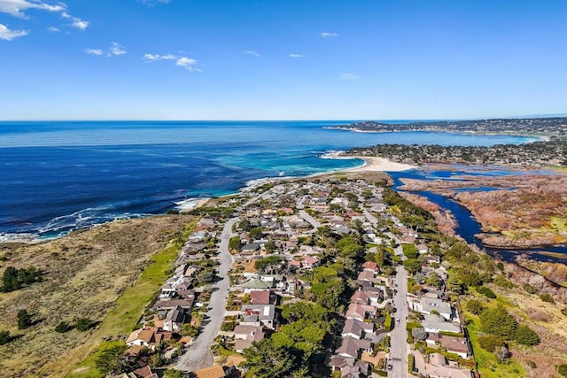 birds eye view of property with a water view and a view of the beach