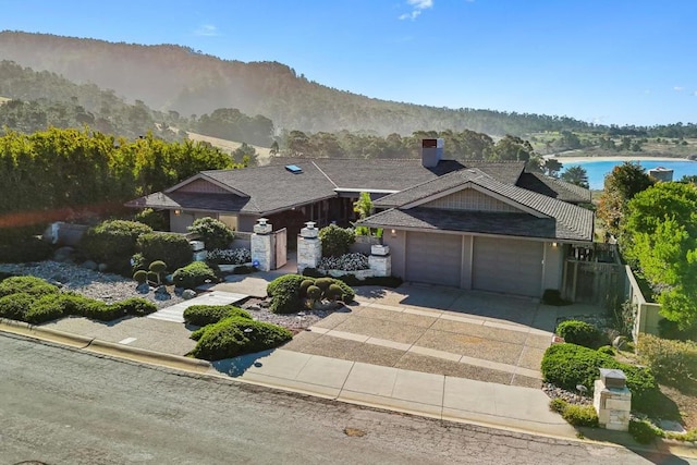 view of front of home featuring a garage and a water and mountain view