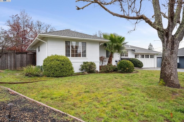 ranch-style home with a garage and a front lawn