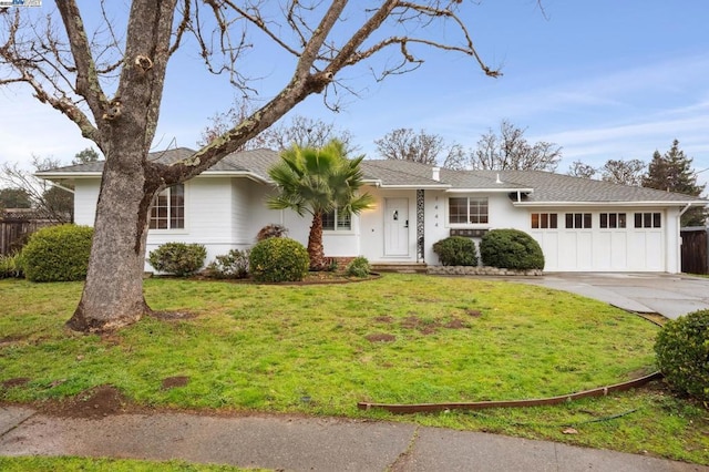 single story home featuring a garage and a front lawn